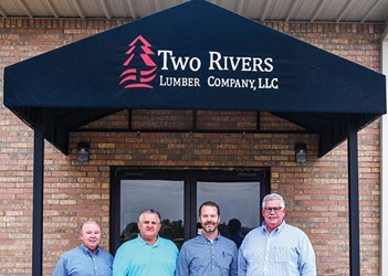 Randell Robinson, Dennis Drinkard, Jay McElroy and Roy Geiger in front of Two Rivers building